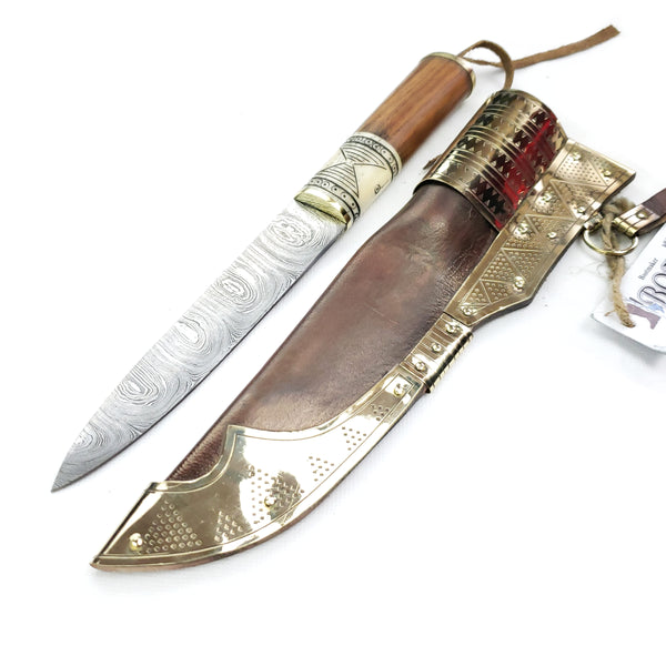 Point toward viewer Rus Viking Damascus Knife #56D is a replica Viking Knife with decorated veg tanned with brass decorations Sheath and features Norse decorative motifs carved in the bone handle accented with brass, and a Damascus blade that is sturdy